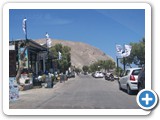 Shops and Restaurants line the road along Perissa Beach - convenience without commercialization.