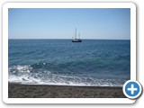 This beautiful black volcanic sand beach lies at the foot of Mt. Prophet Elias.